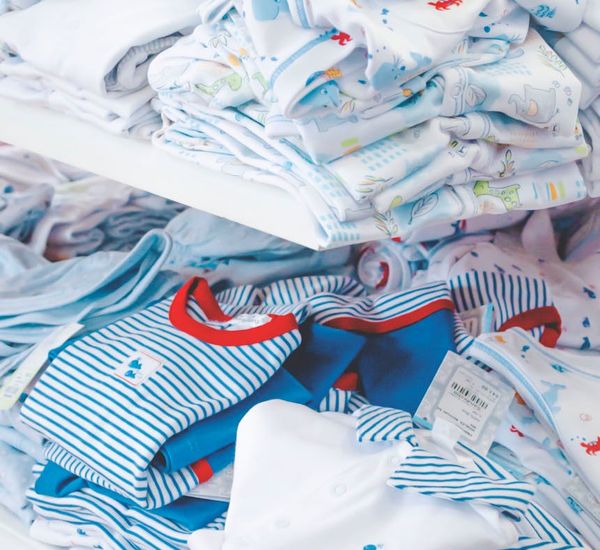 A neatly folded set of comfortable clothes next to a water bottle.