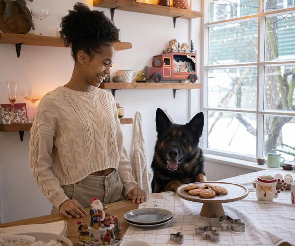 Person smiling while stretching near a window with morning light.